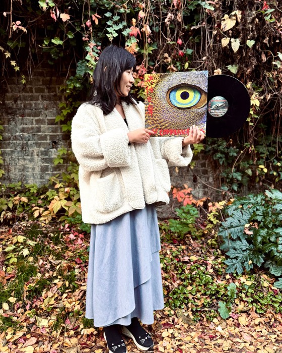 An-Ting 安婷 holding the Lost Communications vinyl in an autumn garden